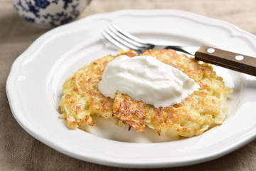 Cabbage patties with sour cream on a plate