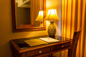 notebook on the table with lamp and chair in retro style