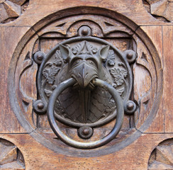 metal handle on a wood carved door