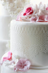 White wedding cake with pink rose