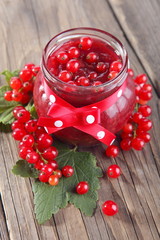 Jam jar of currant jelly and red currants
