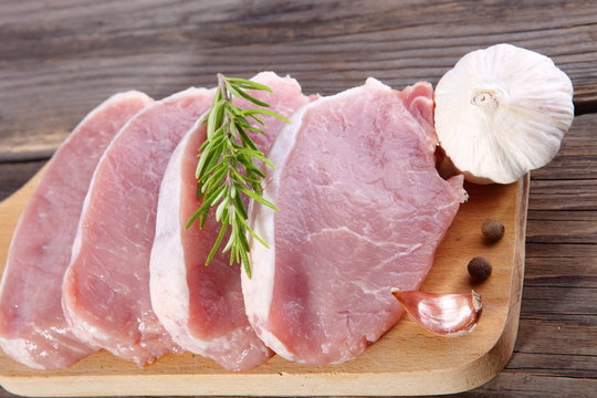 Meat, pork, slices pork loin on wooden board 