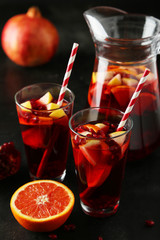 Glasses of sangria on black background
