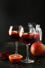 Glass of sangria on black background