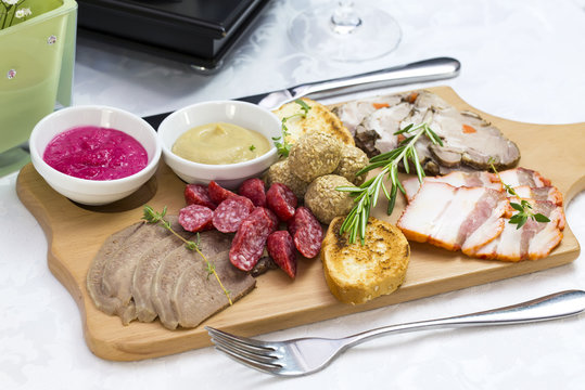 wooden dish with bacon and sausage