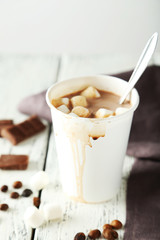 Cup of hot chocolate with marshmallows on white wooden backgroun
