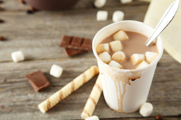 Cup of hot chocolate with marshmallows on grey wooden background