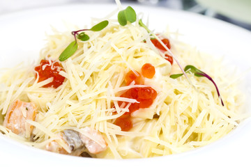 spaghetti with eggs decorated with greenery on a 