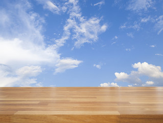 Empty wooden table with blue sky and cloud