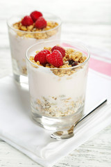 Muesli with yogurt and raspberries in a glass 