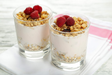 Muesli with yogurt and raspberries in a glass 
