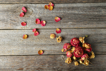 Dried roses on grey wooden background