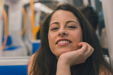 Beautiful curvy girl posing in a metro car