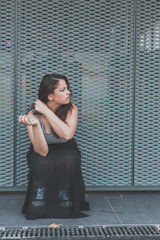 Beautiful curvy girl smoking a cigarette in an urban context