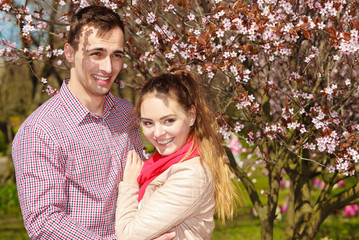 Couple in love walking in park at sunny spring day