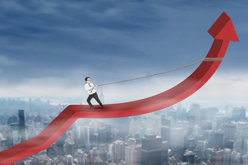 Little businessman pulling arrow upward