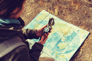 Traveler holding a compass in the forest