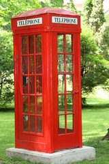 Fototapeta premium English red telephone booth in park settig