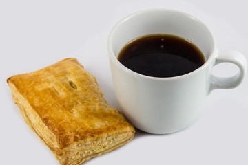 Closeup black coffee and chicken pie isolated on white backgroun