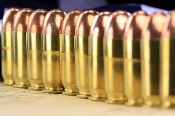 A row of 45 caliber ammunition copper plated bullets