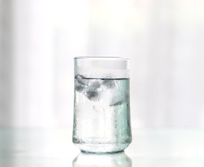 glass of Cool fresh drink with ice cube on the  table