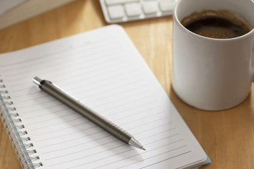 pen with notebook on working table