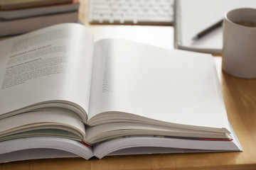 opened book pile put on table