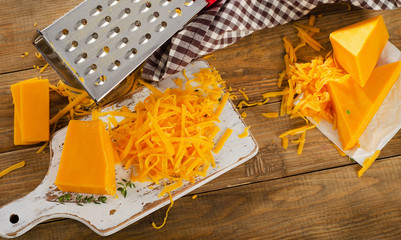 Cheddar Cheese on white cutting Board.