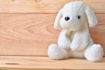 Plush dog toy with wooden background