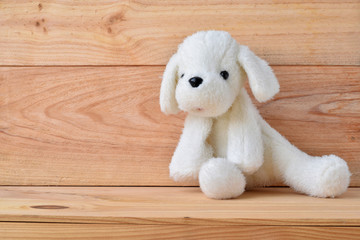 Plush dog toy with wooden background