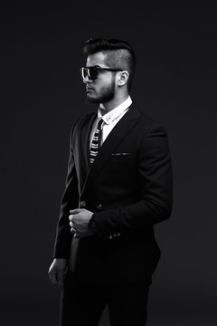 portrait of handsome stylish man in elegant black suit