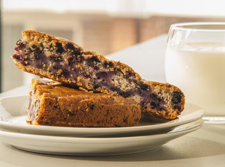Homemade blueberry pastry close up with glass of milk