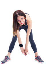 Cheerful sporty woman doing stretching exercise