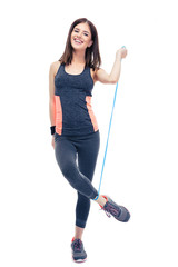 Happy woman standing with jumping rope
