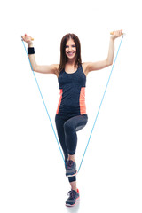 Sporty woman standing with jumping rope