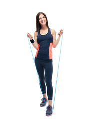 Sporty woman standing with jumping rope