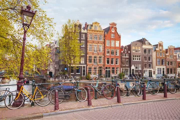 Fotobehang Fietsen geparkeerd op een brug in Amsterdam © andreykr