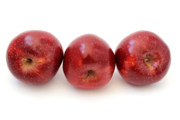 Three red apples are inclined
