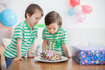Beautiful adorable four year old boy in green shirt, celebrating