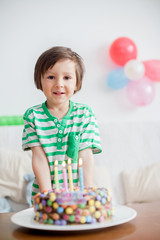 Beautiful adorable four year old boy in green shirt, celebrating