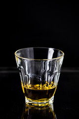 Glasses of whiskey on wood background.