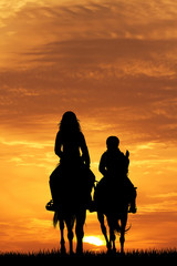 mother and child on horse at sunset © adrenalinapura