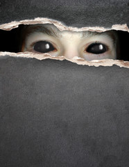 Monster eye in hole of paper