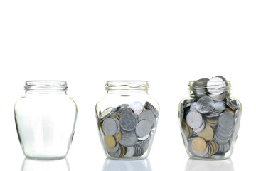 Glass bank for tips with money isolated on white