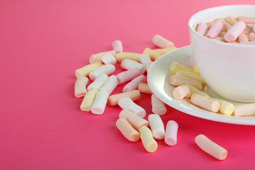 marshmallow in a cup on a pink background