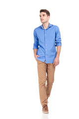 Fototapeta premium casual man walking with his hand in pocket on