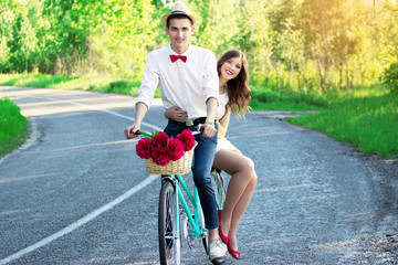 Wedding. Stylish young newlyweds on a vintage bike
