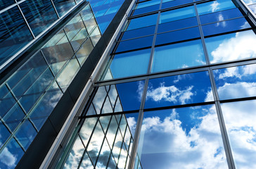 Reflection of the sky and clouds in the windows of  building