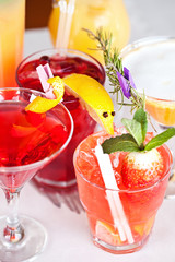 Summer cocktails with pieces of fruit on white background