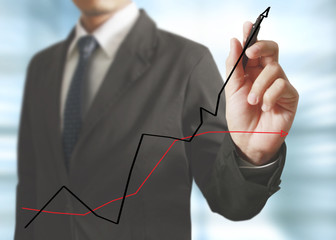 Businessman drawing graphics